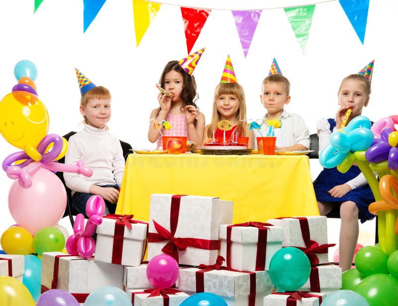 Group of children celebrating birthday. Croup of happy children celebrating birthday behind table royalty free stock images Group of children celebrating birthday. Croup of happy children celebrating birthday behind table royalty free stock images