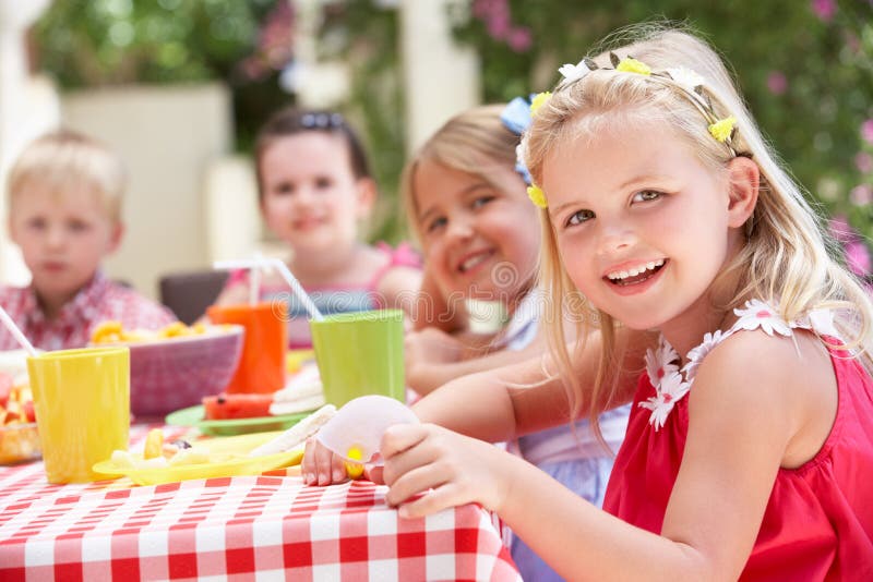 Group Of Children Enjoying Outdoor Tea Party stock photo Group Of Children Enjoying Outdoor Tea Party stock photo
