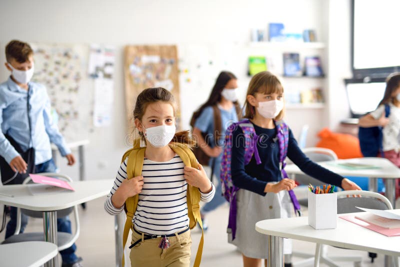 Group of children with face mask back at school after covid-19 quarantine and lockdown. royalty free stock photography
