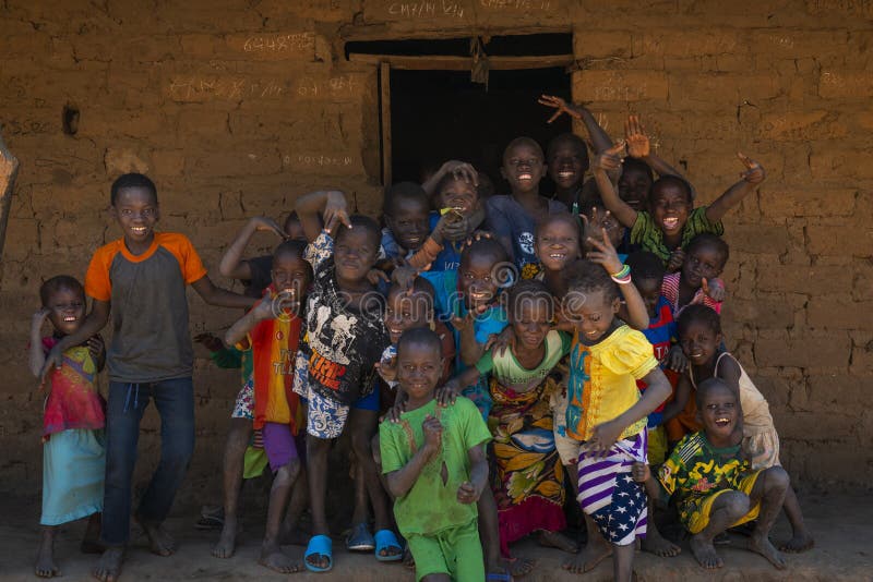 Group of children in front of a house in the village of Mandina Mandinga in the Gabu Region stock photo Group of children in front of a house in the village of Mandina Mandinga in the Gabu Region stock photo