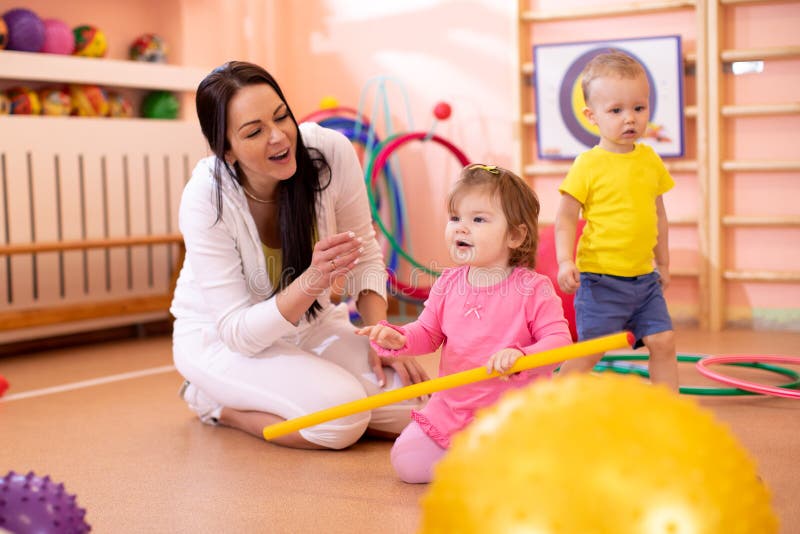 Group of children in gym with nursery teacher royalty free stock photos Group of children in gym with nursery teacher royalty free stock photos