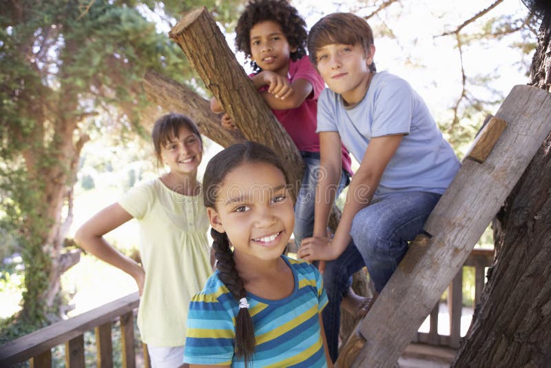 Group Of Children Hanging Out In Treehouse Together stock photos Group Of Children Hanging Out In Treehouse Together stock photos