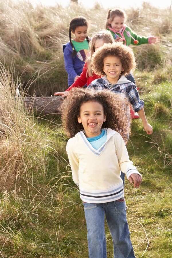 Group Of Children Playing In Field Together