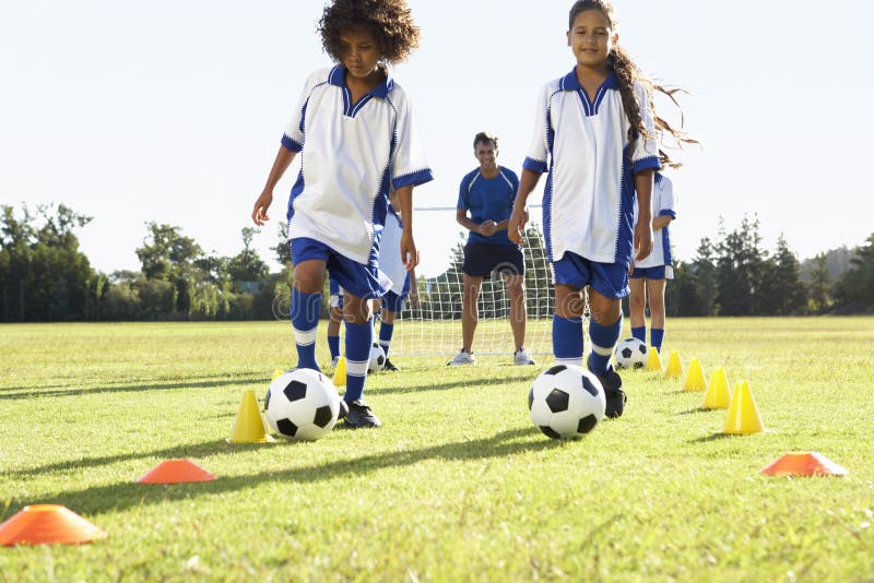 Group Of Children In Soccer Team Having Training With Coach royalty free stock image Group Of Children In Soccer Team Having Training With Coach royalty free stock image