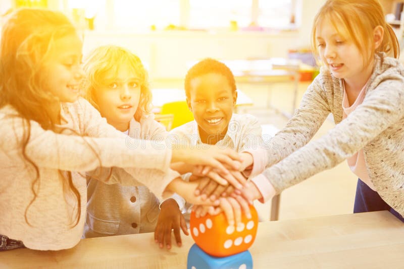 Group of children stacks hands as a teamwork concept stock image Group of children stacks hands as a teamwork concept stock image