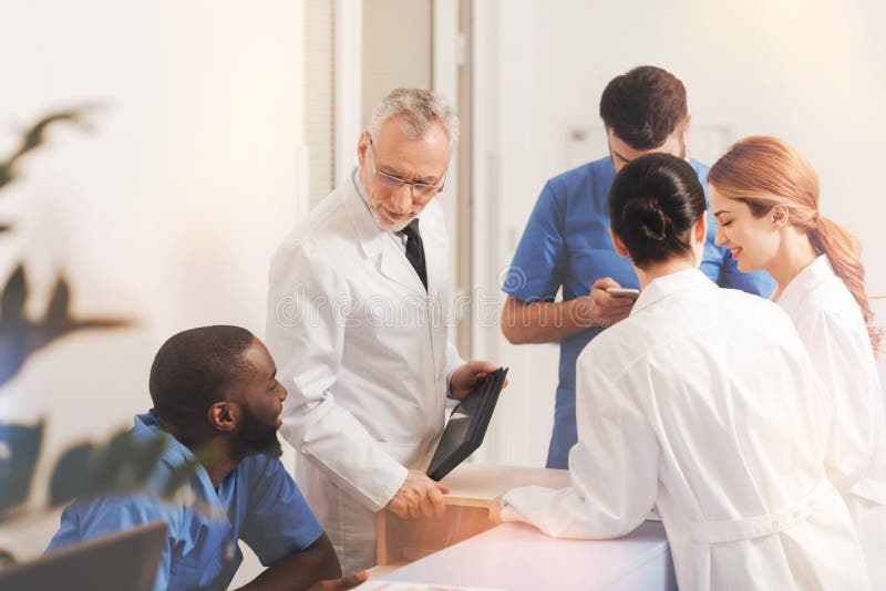 Group of colleagues having interesting conversation stock photography Group of colleagues having interesting conversation stock photography