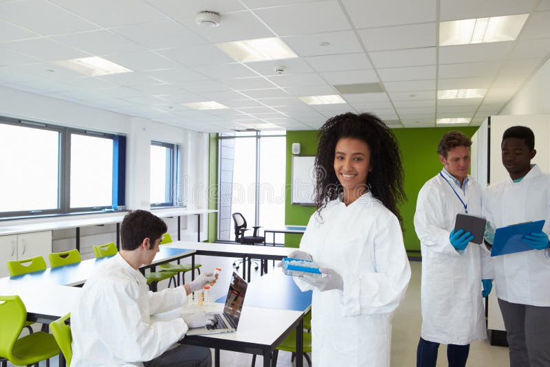 Group of College Students in Science Class with Experiment Stock Photo