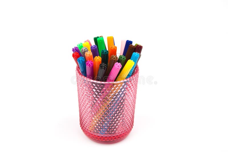 Group of color felt-tipped pens in a glass, white background
