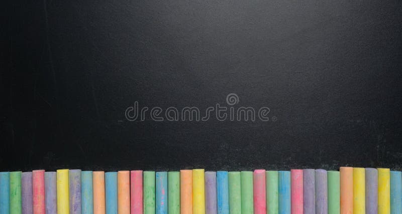 Group of colorful chalk rubbed out on blackboard or chalkboard background,  can be use as concept for school education, dark wall backdrop , design  template , etc. Stock Photo