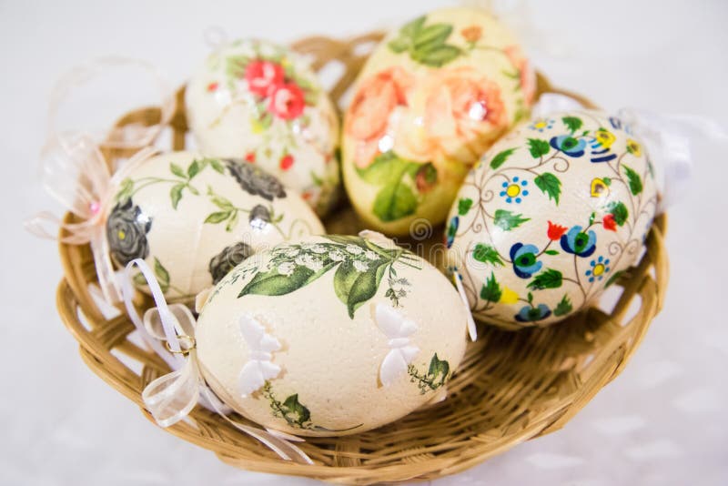 Group of Colorful Easter Eggs Decorated with Flowers Made by Decoupage Technique, in a Basket