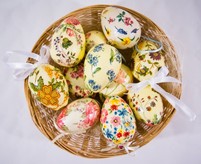 Group of Colorful Easter Eggs Decorated with Flowers Made by Decoupage Technique, in a Basket