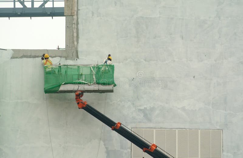 Group of construction workers standing in the mobile crane basket royalty free stock photo Group of construction workers standing in the mobile crane basket royalty free stock photo