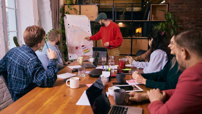 Group of coworkers discussing tasks in modern office. royalty free stock photography