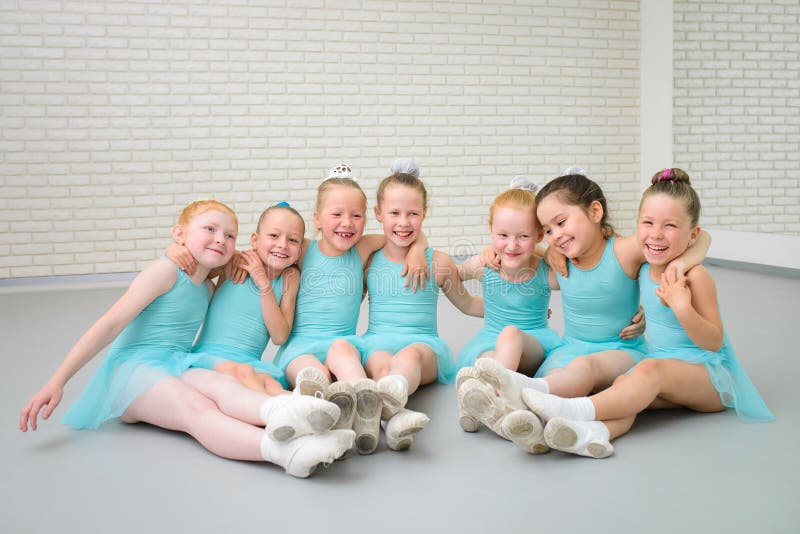 Group of cute little ballet dancers having fun at dance school class. stock images