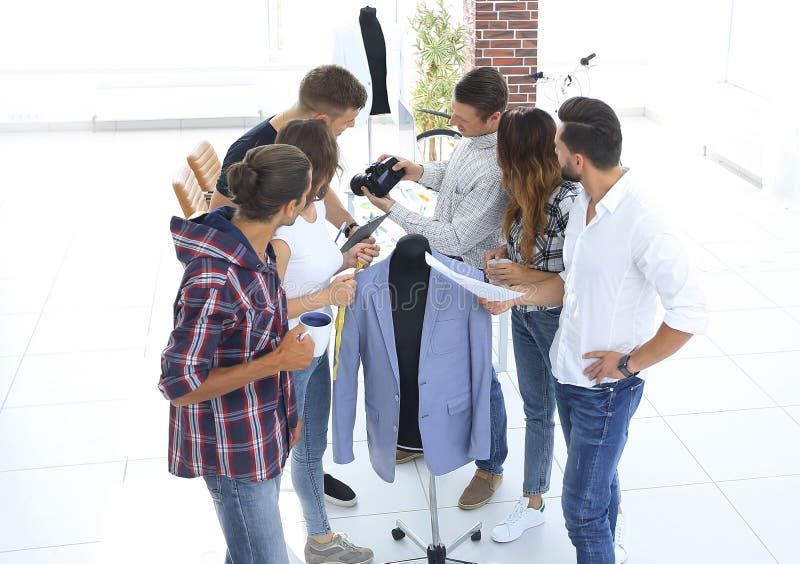Group of Designers Discussing New Models of Men`s Clothing. Stock Image ...