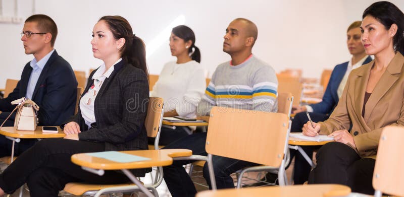 Business people listening to speaker at conference royalty free stock image