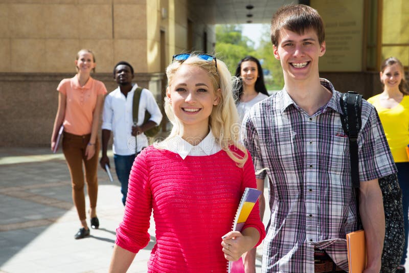 Group of diverse students walking together royalty free stock image