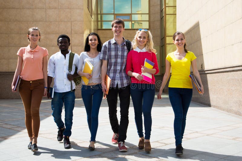 Group of diverse students walking together royalty free stock photography