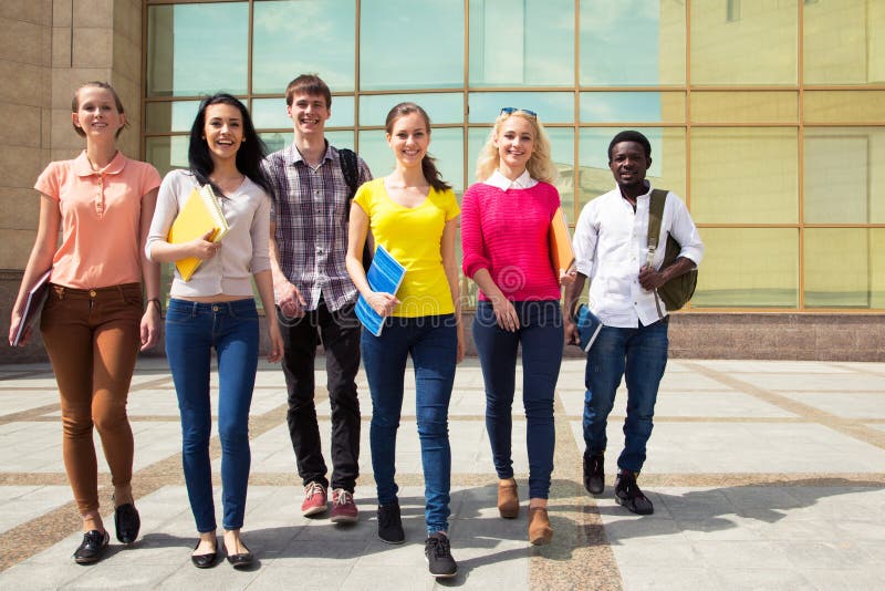Group of diverse students walking together stock image