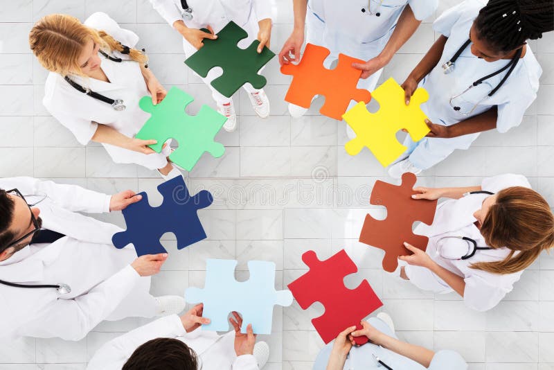 Group Of Doctors Holding Colorful Puzzle stock image