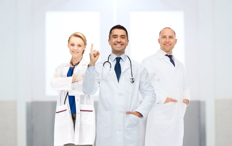 Group of doctors at hospital pointing finger up