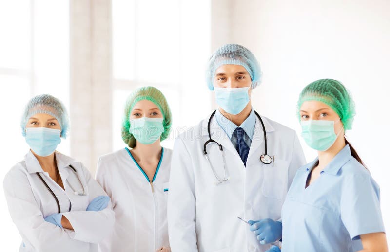 Group of doctors in operating room stock images