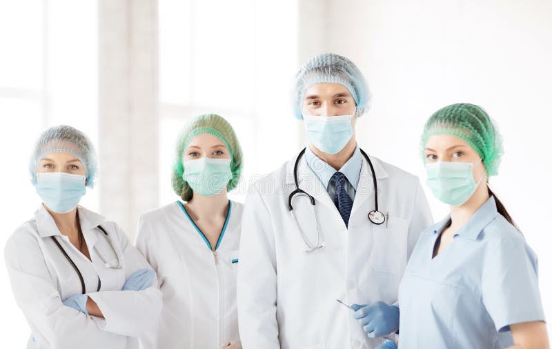Group of doctors in operating room stock photos