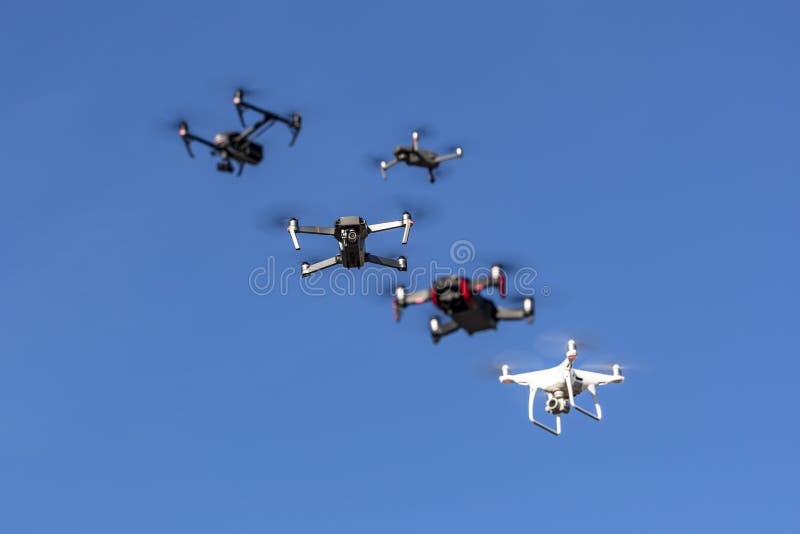 A Group Of Multiple Drones Fly Together Through The Air Against A Blue Sky royalty free stock image A Group Of Multiple Drones Fly Together Through The Air Against A Blue Sky royalty free stock image