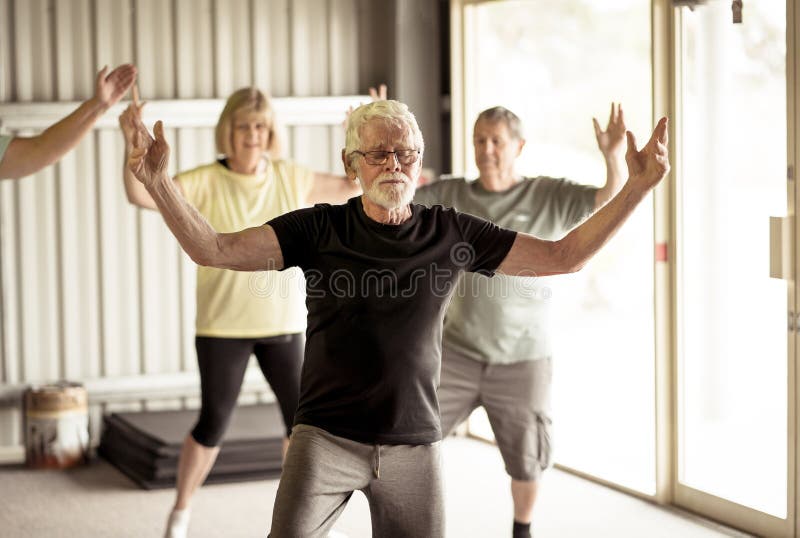 Group of seniors in Tai Chi class exercising in an active retirement lifestyle. Mental and physical health benefits of exercise and fitness in elderly people. Senior health care and wellbeing concept. Group of seniors in Tai Chi class exercising in an active retirement lifestyle. Mental and physical health benefits of exercise and fitness in elderly people. Senior health care and wellbeing concept