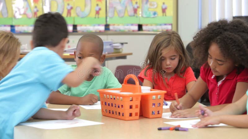 Group Of Elementary Age Children Using Coloring Pens