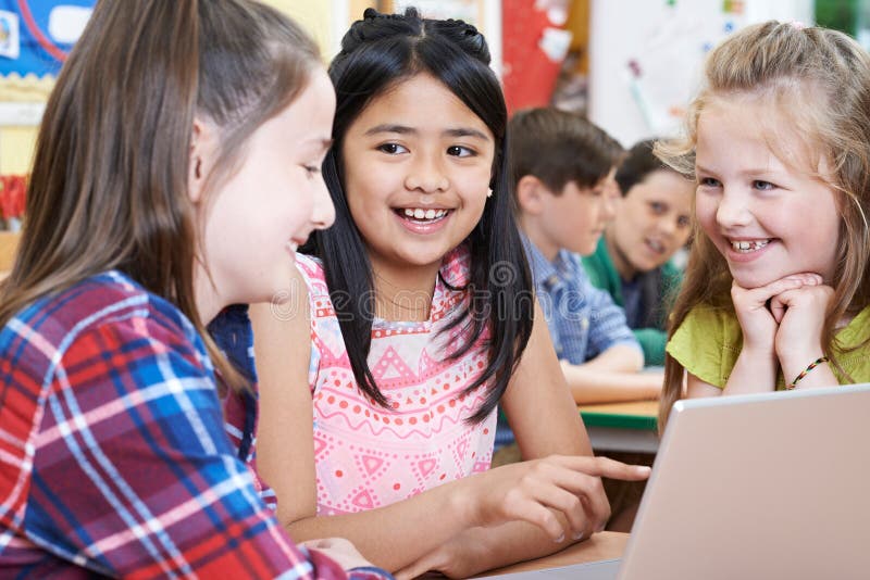 Group of Elementary School Children Working Together in Computer Stock