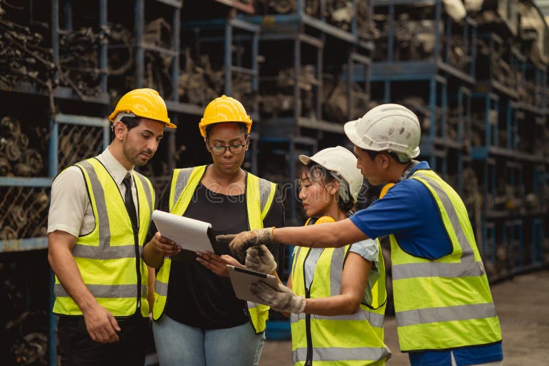 Group of engineer industry worker team working together help solving problem in metal factory stock photo