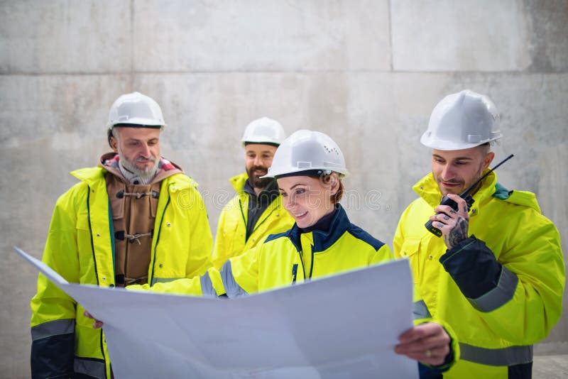 A Group of Engineers Standing Against Concrete Wall on Construction