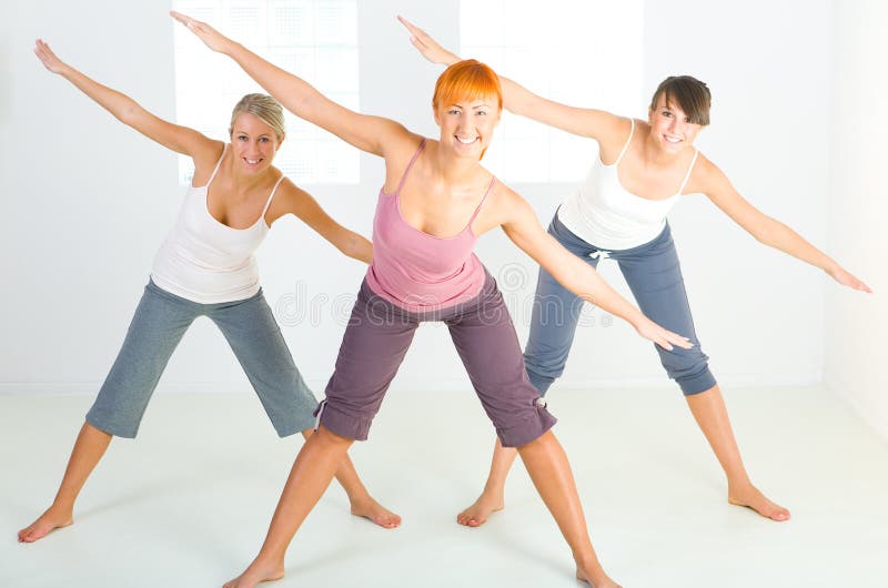 Group of women doing fitness exercise. They're looking at camera. Front view. Group of women doing fitness exercise. They're looking at camera. Front view.