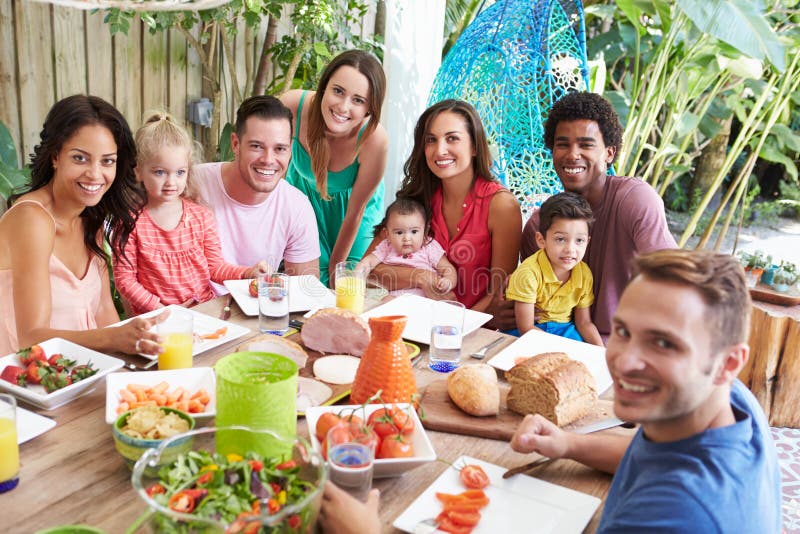 Group Of Families Enjoying Outdoor Meal At Home stock photography Group Of Families Enjoying Outdoor Meal At Home stock photography