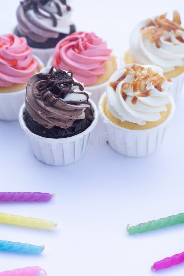 Group of fancy cup cakes on wooden table, birthday celebration concept stock images Group of fancy cup cakes on wooden table, birthday celebration concept stock images
