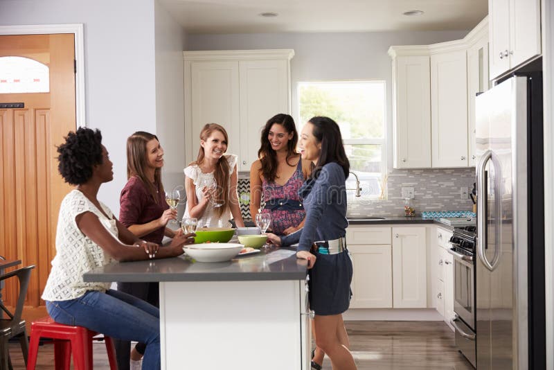 Group of Female Friends Enjoying Pre Dinner Drinks at Home Stock Photo