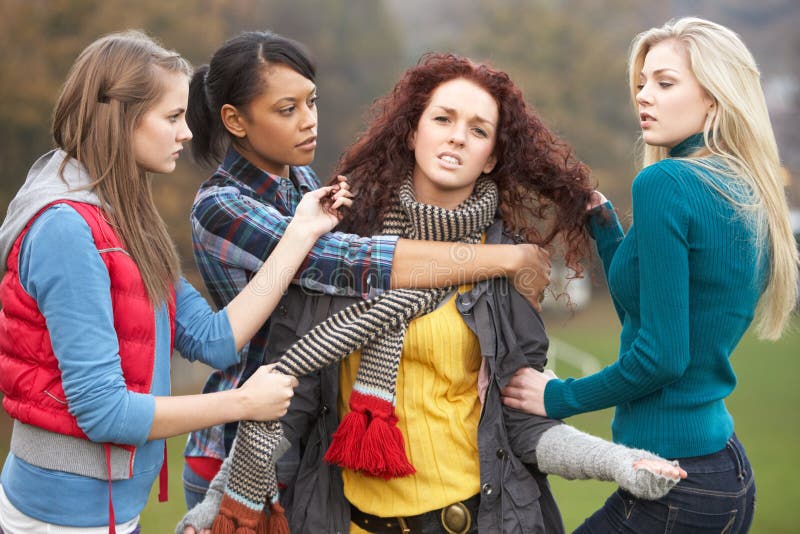 Group Of Female Teenagers Bullying Girl stock photography.