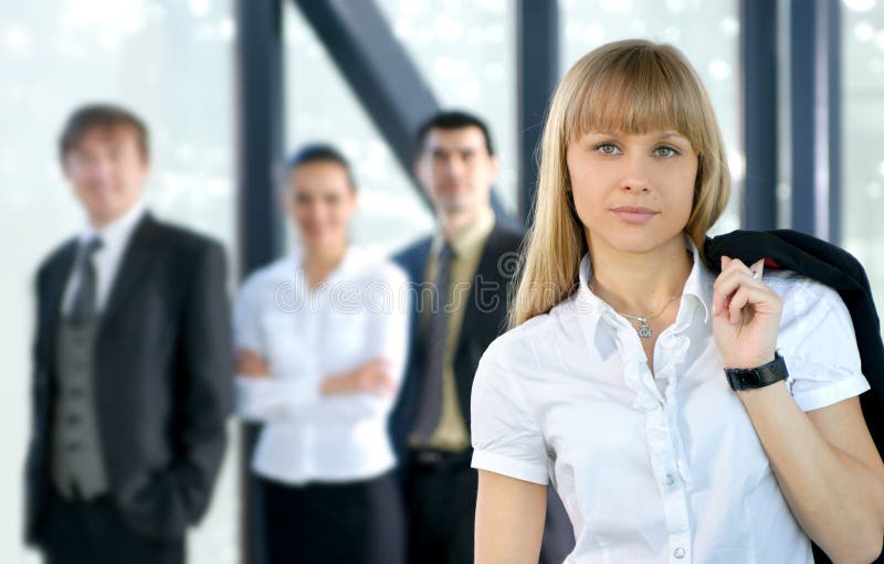 A group of four business persons in an office