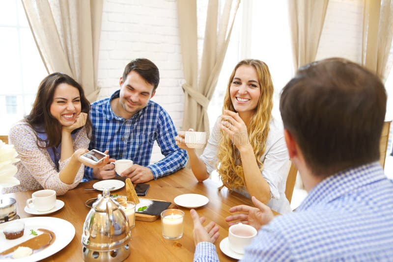 Group of Four Happy Friends Meeting and Talking and Eating Desserts ...