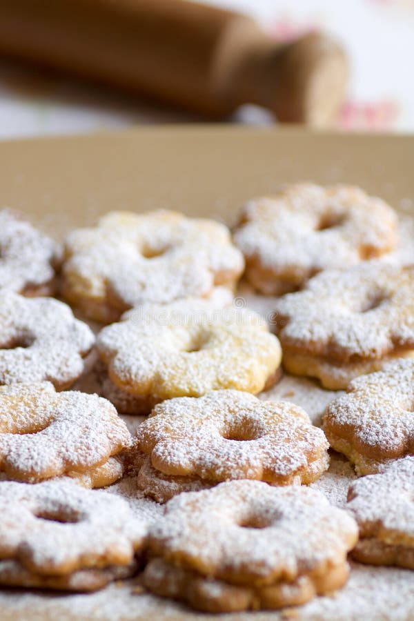Group of canestrelli biscuits covered of icing sugar on a plate royalty free stock photos