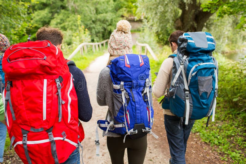 Group of friends with backpacks hiking