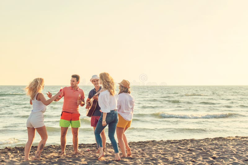 Group of friends play on the beach royalty free stock photography Group of friends play on the beach royalty free stock photography