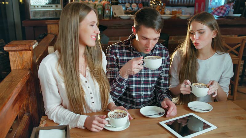 Group of friends drinking coffee and talking In cafe. Hot cafe video