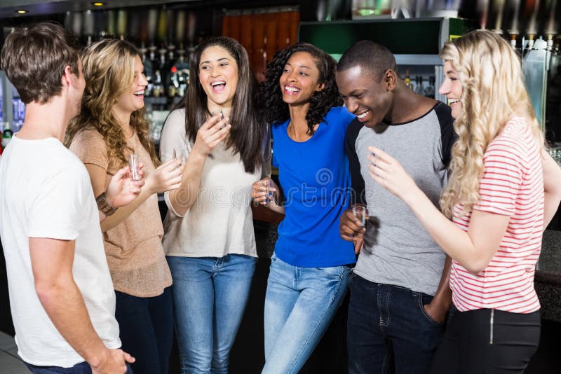 Group of friends drinking shots royalty free stock photography