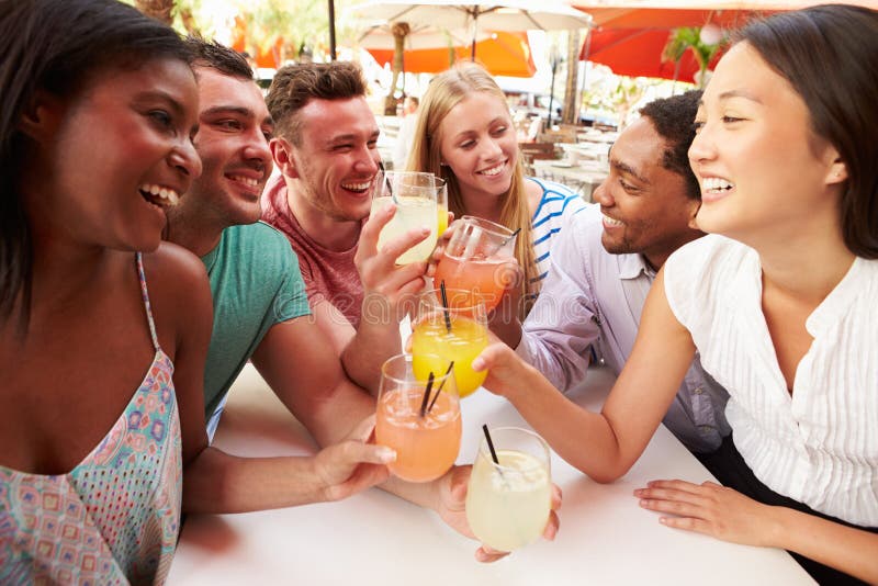 Group Of Friends Enjoying Drinks In Outdoor Restaurant