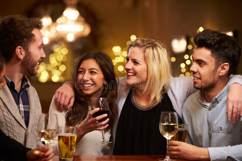 Group Of Friends Enjoying Evening Drinks In Bar royalty free stock image Group Of Friends Enjoying Evening Drinks In Bar royalty free stock image