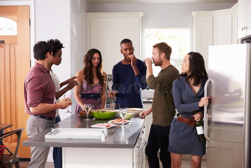 Group of Friends Enjoying Pre Dinner Drinks at Home Stock Image - Image