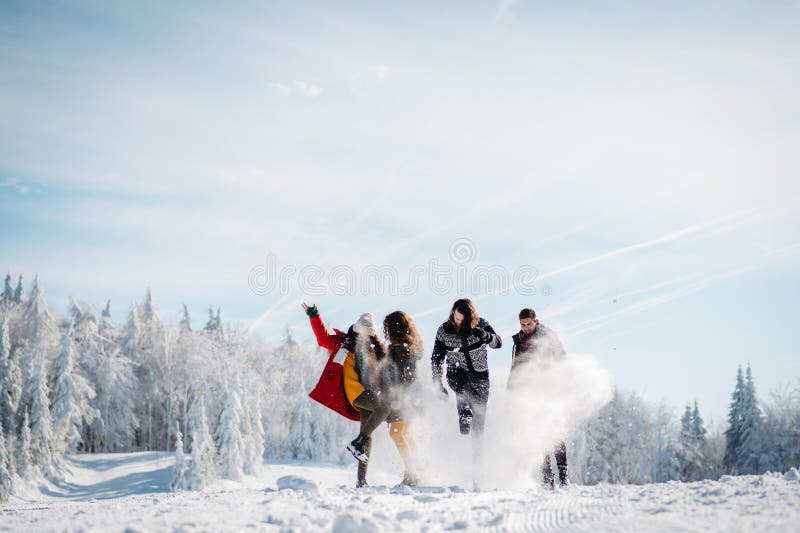 Group of friends enjoying winter time in snowy nature. stock photos