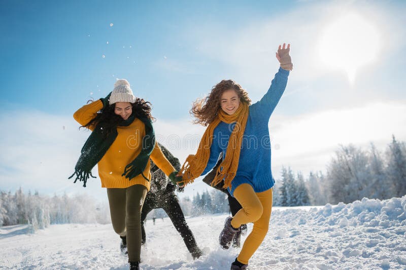 Group of friends enjoying winter time in snowy nature. stock photography